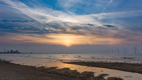 Scenic view of beach against sky during sunset