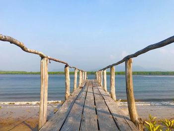 Pier over sea against clear sky