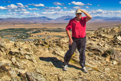 Full length of man standing against landscape