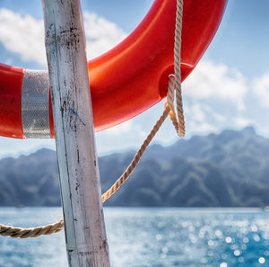 Close-up of rope against sea against sky