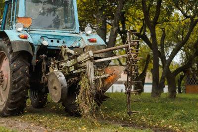 Tractor cultivating field at fall. harvest crop season. farmer in tractor preparing land with 