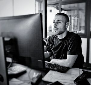 Businessman using desktop pc in office