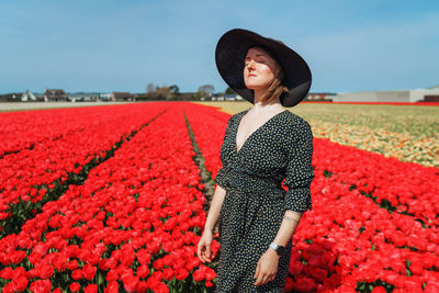 Woman standing on tulip field