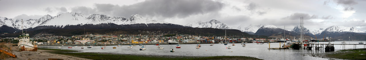 Panoramic view of buildings and mountains against sky