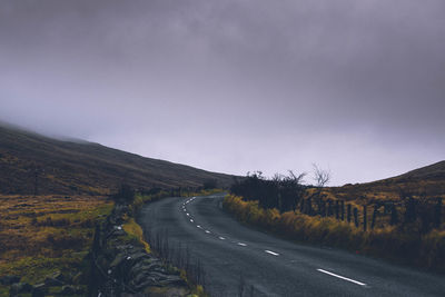 Road amidst landscape against sky