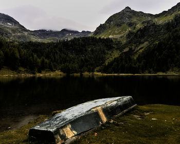 Scenic view of lake by mountains against sky