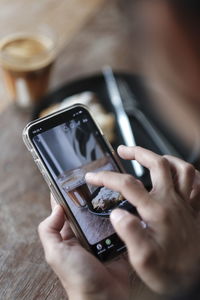 Midsection of woman using mobile phone