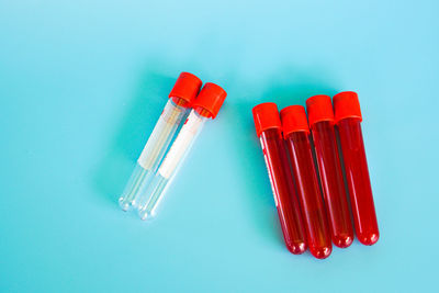 High angle view of colored pencils against blue background