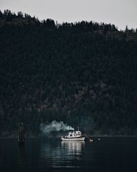 Boat sailing in lake against sky