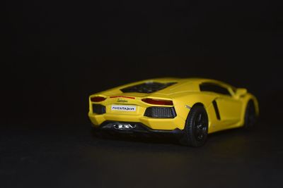 Close-up of toy car against black background