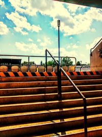 Railing against cloudy sky