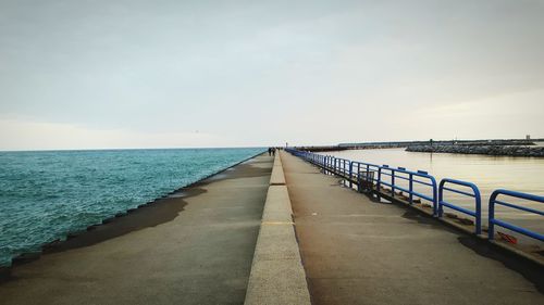 Empty jetty leading to calm sea