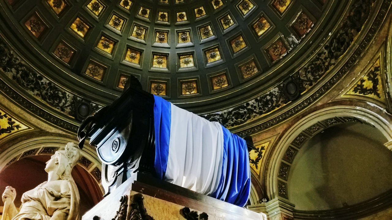 low angle view, architecture, indoors, human representation, built structure, statue, no people, dome, place of worship, sculpture, spirituality, travel destinations, day, clock