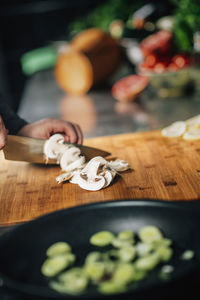 Close-up of chef preparing food on cutting board at restaurant