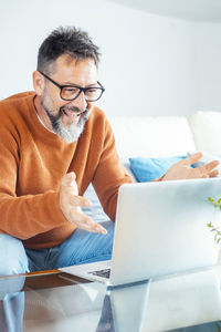 Young man using laptop at home