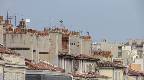 Buildings in city against clear sky