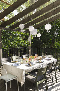 Lanterns hanging over dining table at patio