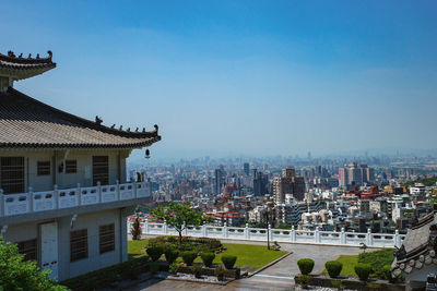 Buildings in city against blue sky