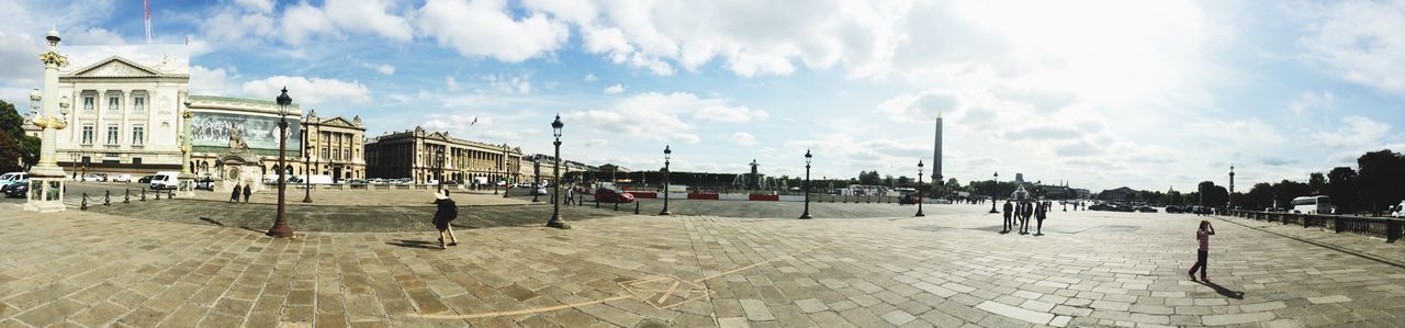 sky, building exterior, architecture, built structure, cloud - sky, large group of people, cloud, incidental people, person, men, lifestyles, leisure activity, cloudy, walking, city, day, panoramic, travel destinations, outdoors