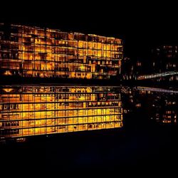 Illuminated buildings in city at night