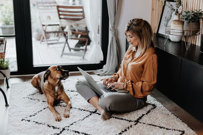 Businesswoman using laptop at home