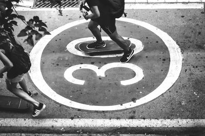 Low section of people skateboarding on street