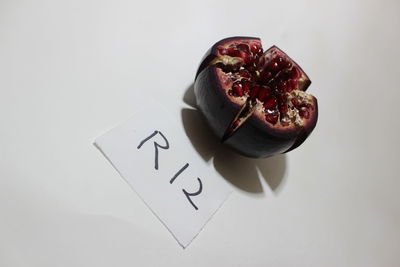 High angle view of fruits on table against white background