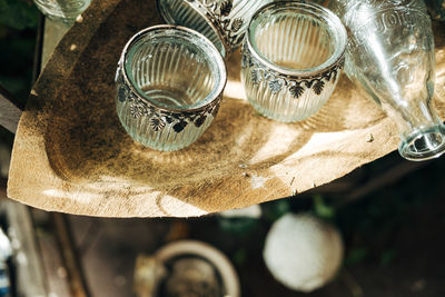 Glass vases in wooden bowl