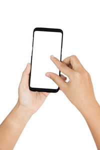 Close-up of hand holding smart phone against white background