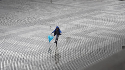 High angle view of woman walking on street