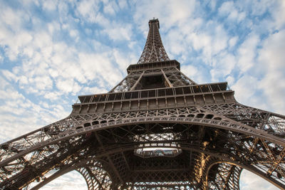 Low angle view of eiffel tower against cloudy sky