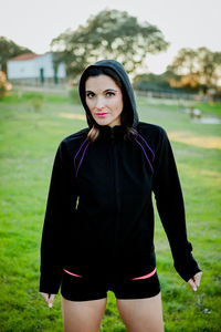 Portrait of woman in hood standing at park