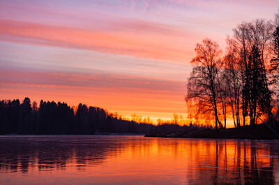 Scenic view of lake against romantic sky at sunset