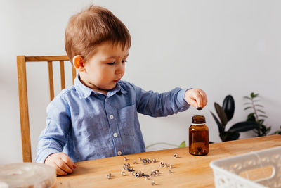 Boy looking at camera on table