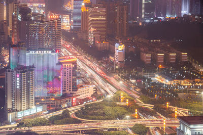 High angle view of illuminated city street and buildings at night