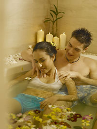 Close-up of man massaging woman in bathtub