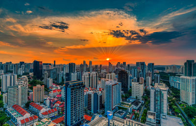 Aerial view of modern buildings against sky during sunset