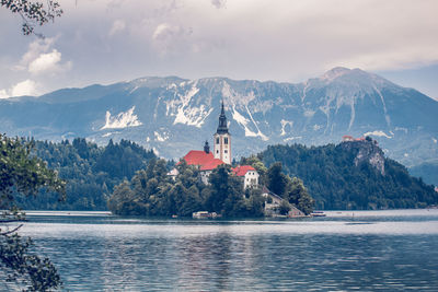 Panoramic view of lake and buildings against sky