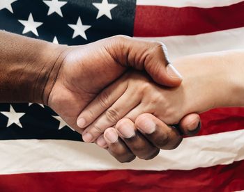 Cropped hand of man holding flag