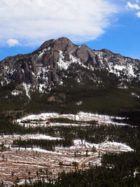 Scenic view of lake by mountains against sky