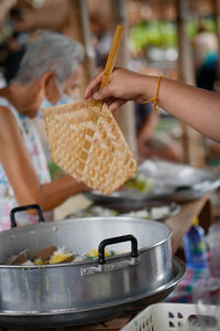 Close-up of woman holding ice cream in kitchen