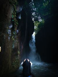 Rear view of man standing on rock