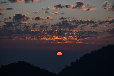 Scenic view of silhouette trees against romantic sky at sunset