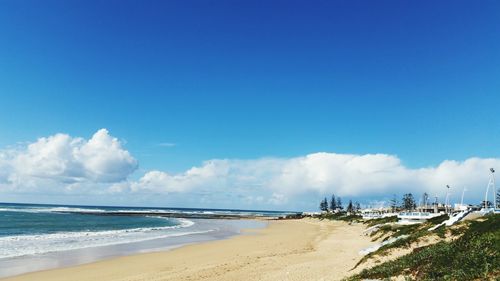 Panoramic view of beach against blue sky