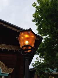 Low angle view of illuminated street light against sky