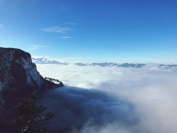 Scenic view of mountains against blue sky