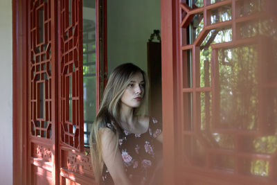 Woman standing on doorway