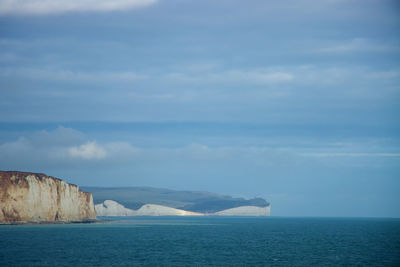 White chalk cliffs, sea and clouds from afar, seven sisters eastbourne