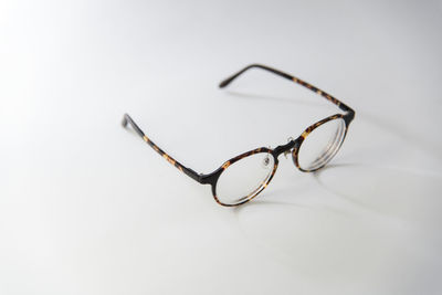Close-up of eyeglasses against white background