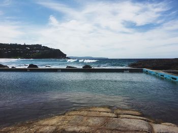 Scenic view of sea against cloudy sky